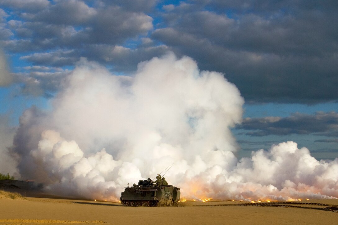 Lithuanian soldiers fire a smoke screen from an M113A1 armored personnel carrier during a joint live-fire exercise with U.S. soldiers at the Great Lithuanian Hetman Jonusas Radvila Training Regiment in Rukla, Lithuania, May 22, 2015. 