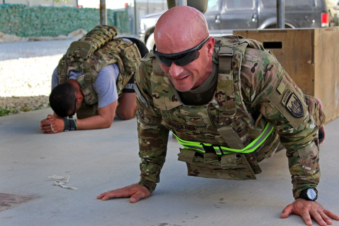 U.S. Army Maj. Jason Pelletier does push-ups in his body armor as part ...