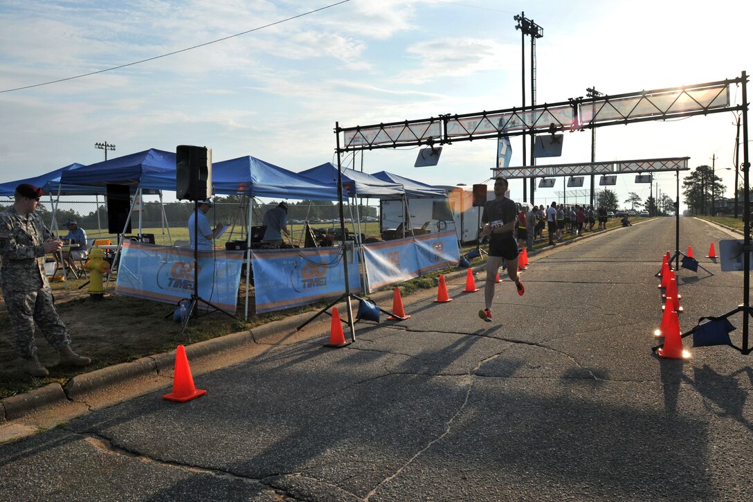 Army 2nd Lt. Matthew Thwaites crosses the finish line during the All American Week 10-mile run on Fort Bragg, N.C. May 19, 2015. Thwaites is assigned to the 82nd Airborne Division's 2nd Battalion, 508th Parachute Infantry Regiment, 2nd Brigade Combat Team.