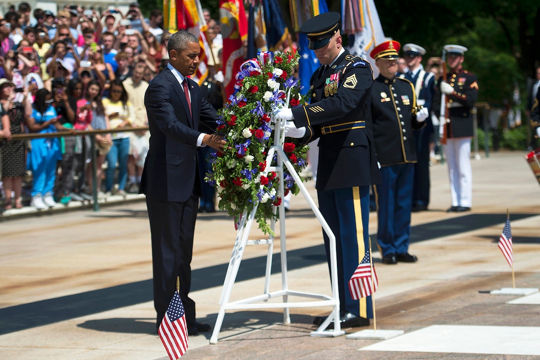 President Barack Obama lays a wreath at the Tomb of the Unknown Soldier to observe Memorial Day at Arlington National Cemetery in Arlington, Va., May 25, 2015.