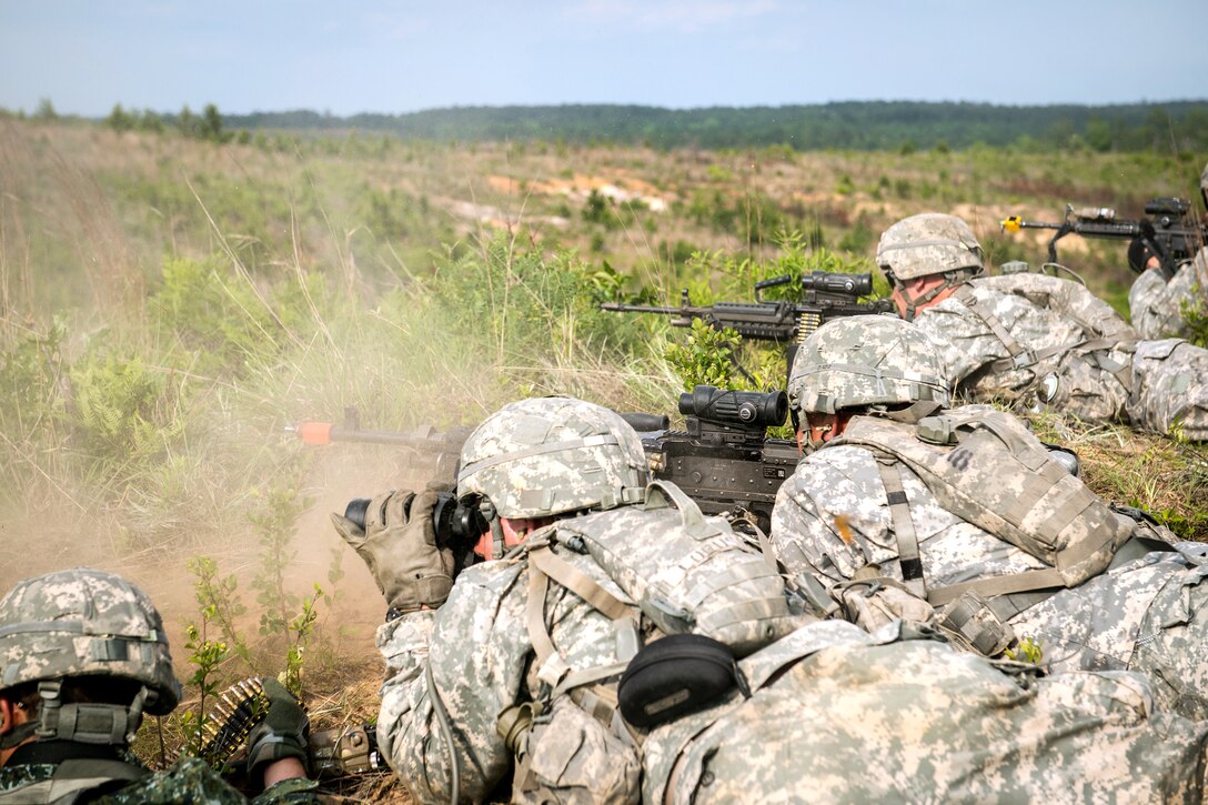 Soldiers seize the high ground to engage simulated enemy forces during a combined arms live-fire exercise on Fort Benning, Ga., May 14, 2015.