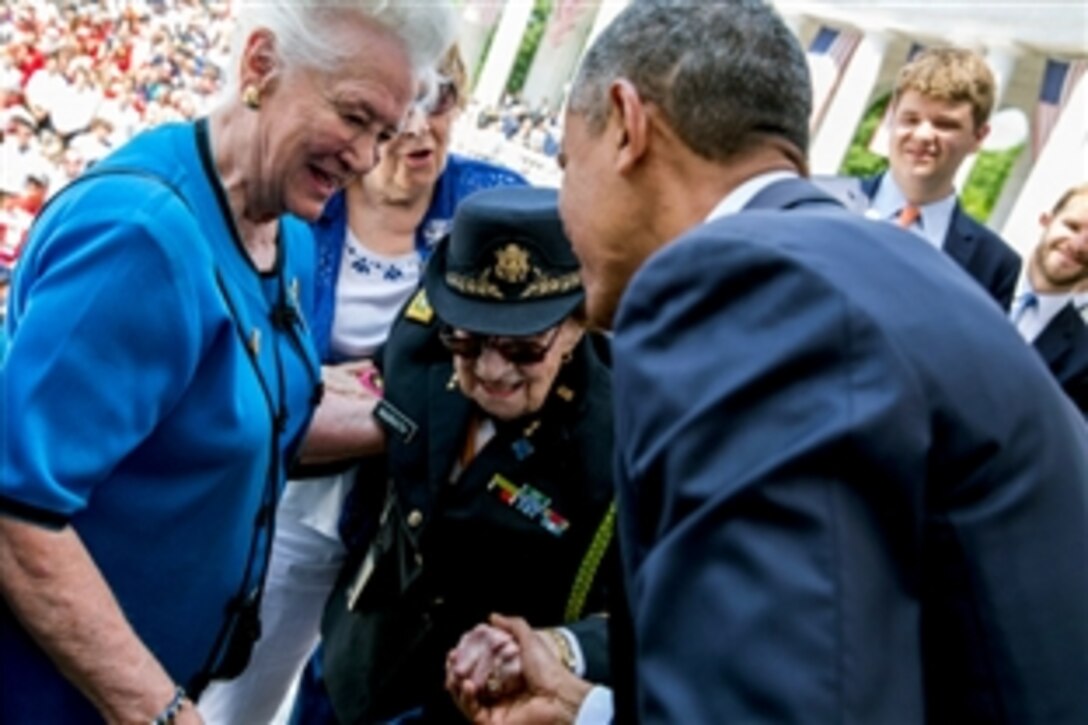 President Barack Obama greets 107-year-old retired Army Lt. Col. Luta Mae Cornelius McGrath, a World War II veteran, after a Memorial Day ceremony at the Arlington National Cemetery Memorial Amphitheater in Arlington, Va., May 25, 2015. 