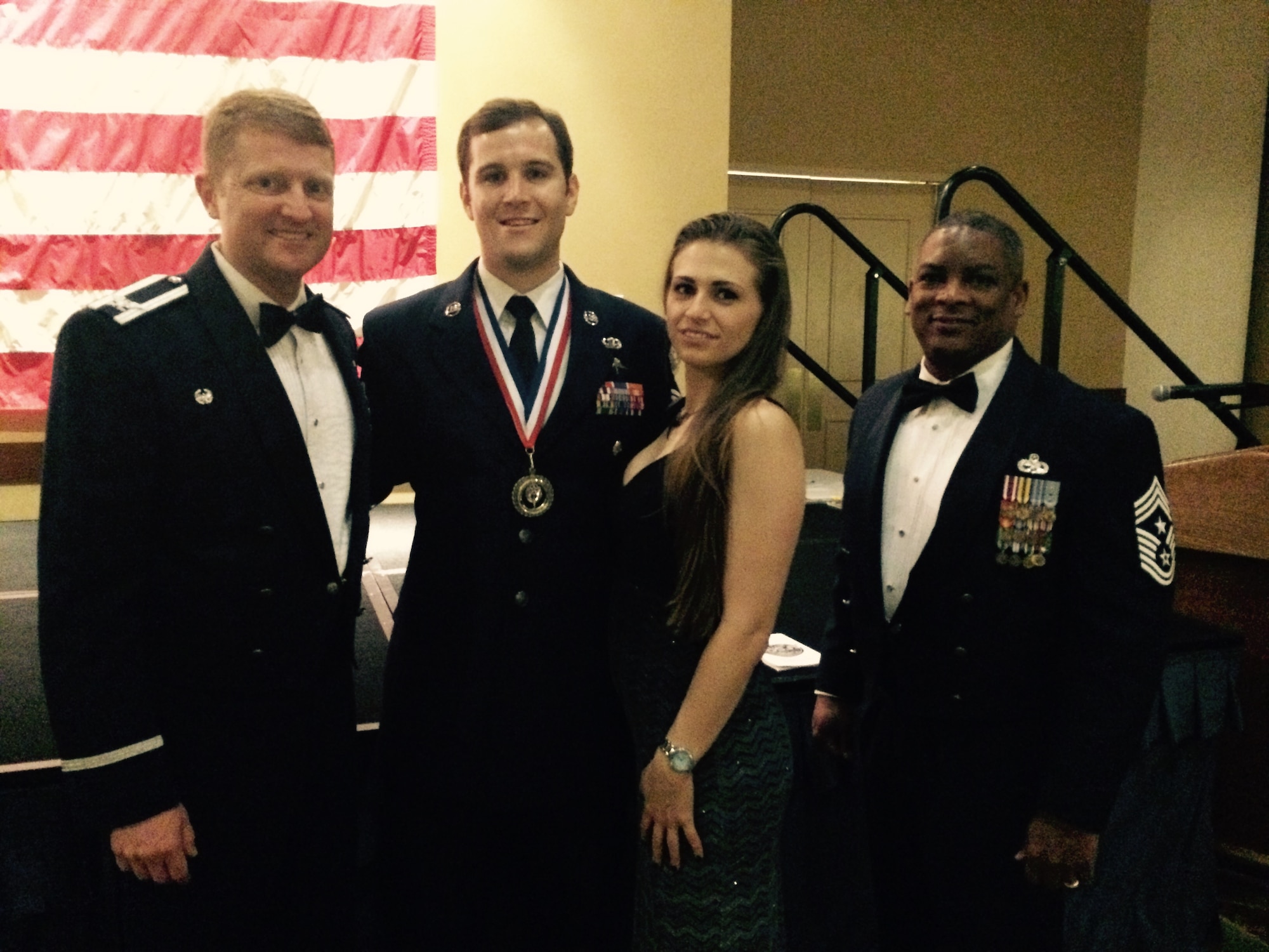 From left, Col. William Freeman, 353rd Special Operations Group commander, Staff Sgt. Travis Jordan and his wife, Christina, and Chief Master Sgt. Gilbert Edwards, 353rd SOG command chief, pose for a picture during a banquet honoring the Air Force Special Operations Command's 2014 Outstanding Airmen and Civilians of theYear held May 14 at Hurlburt Field, Fla.  Jordan, a combat controller, assigned to the 320th Special Tactics Squadron, was recognized as AFSOC’s Airman of the Year and will compete in the airman category for the 2015 12 Outstanding Airmen of the Year Award.  (Courtesy Photo)
