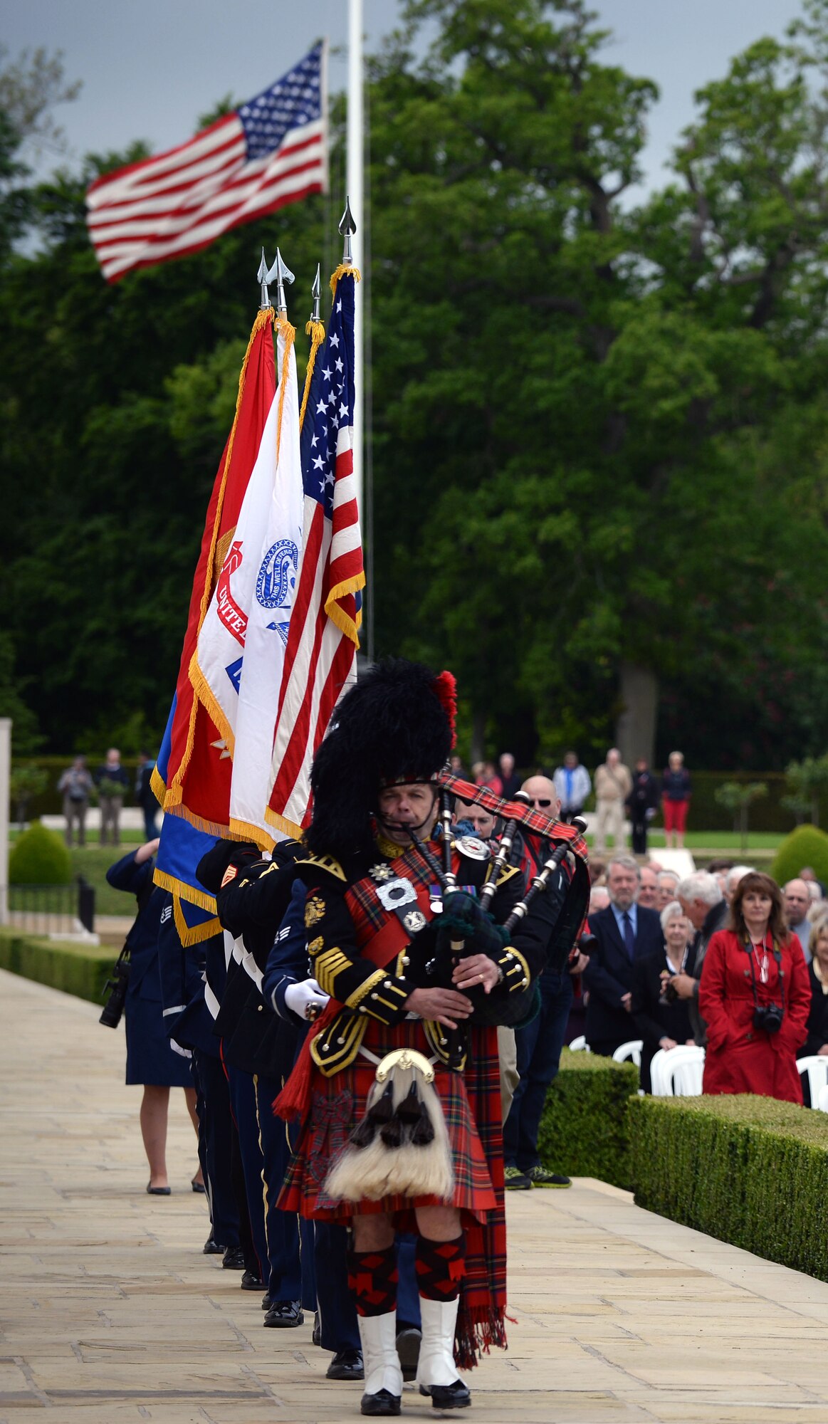 A joint service color team marches to post the colors during the Memorial Day Ceremony May 25, 2015, at the Cambridge American Cemetery and Memorial in Cambridge, England. The honor guard also performed a three-volley salute during the service in remembrance of the fallen heroes. (U.S. Air Force photo by Senior Airman Christine Halan)