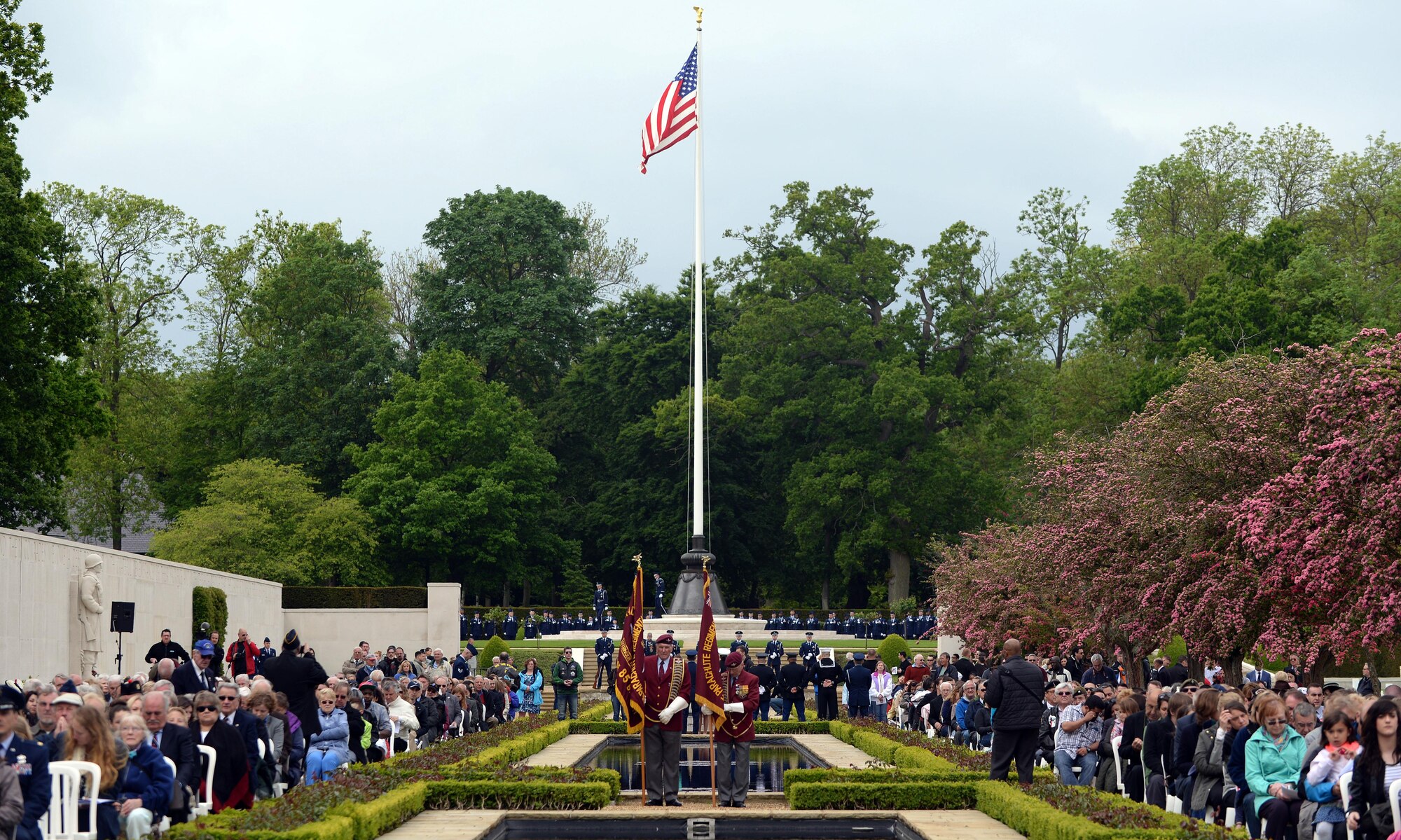 RAF Midenhall base honor guard post colors during the annual Memorial Day ceremony at the Cambridge American Cemetery and Memorial May 25, 2015, in Cambridge, England. The honor guard also performed a three-volley salute during the service in remembrance of the fallen heroes. (U.S. Air Force photo by Senior Airman Christine Halan/Released)