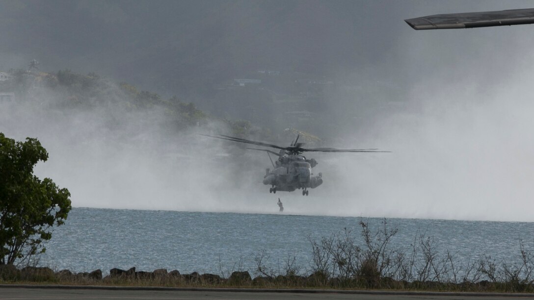 U.S. Marines with the 15th Marine Expeditionary Unit’s Maritime Raid Force helocast out of a CH-53 Super Stallion aboard Marine Corps Base Hawaii, May 14, 2015. These Marines practiced helocasting to ensure they are prepared for any type of mission. (U.S. Marine Corps photo by Cpl. Anna Albrecht/Released)