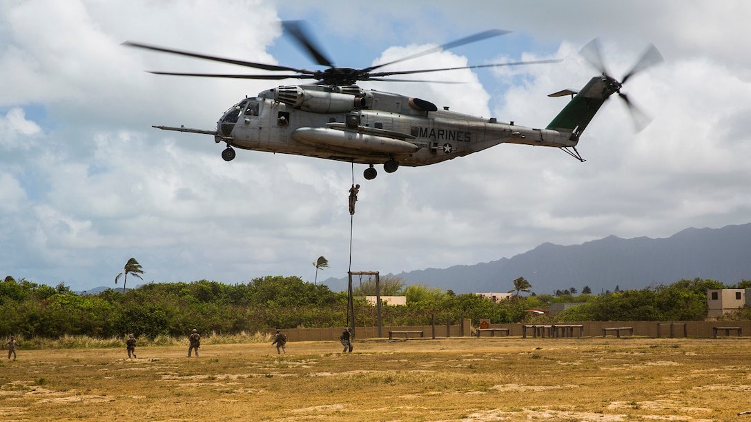 U.S. Marines with the 15th Marine Expeditionary Unit’s Maritime Raid Force security element fast rope out of a CH-53E Super Stallion aboard Marine Corps Base Hawaii, May 12, 2015. Fast roping gives the MRF the ability to rapidly insert combat forces onto an objective. (U.S. Marine Corps photo by Cpl. Anna Albrecht/Released)