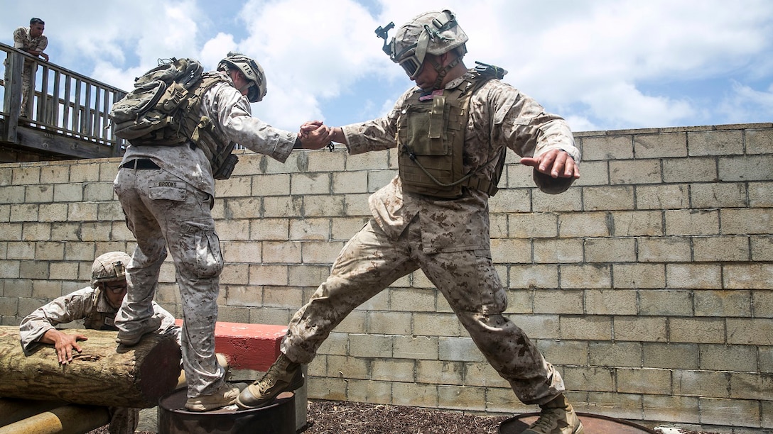 U.S. Marines with the 15th Marine Expeditionary Unit’s Maritime Raid Force work together to complete an obstacle at a leadership reaction course aboard Marine Corps Base Hawaii, May 18, 2015. All of the obstacles required a great amount of teamwork and initiative, building the Marines leadership skills and confidence in each other’s leadership abilities. (U.S. Marine Corps photo by Cpl. Anna Albrecht/Released)