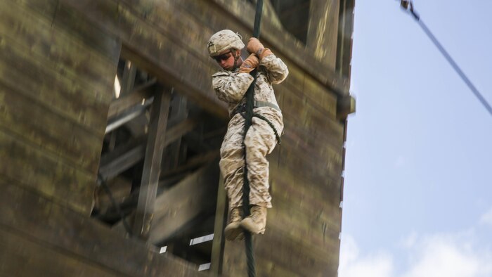 U.S. Marine Lance Cpl. Zane Harmon fast ropes from a tower aboard Marine Corps Base Hawaii, May 12, 2015. Harmon is part of the 15th Marine Expeditionary Unit’s Maritime Raid Force security element. These Marines practice fast roping to ensure they are prepared for any type of mission during deployment. (U.S. Marine Corps photo by Cpl. Anna Albrecht/Released)