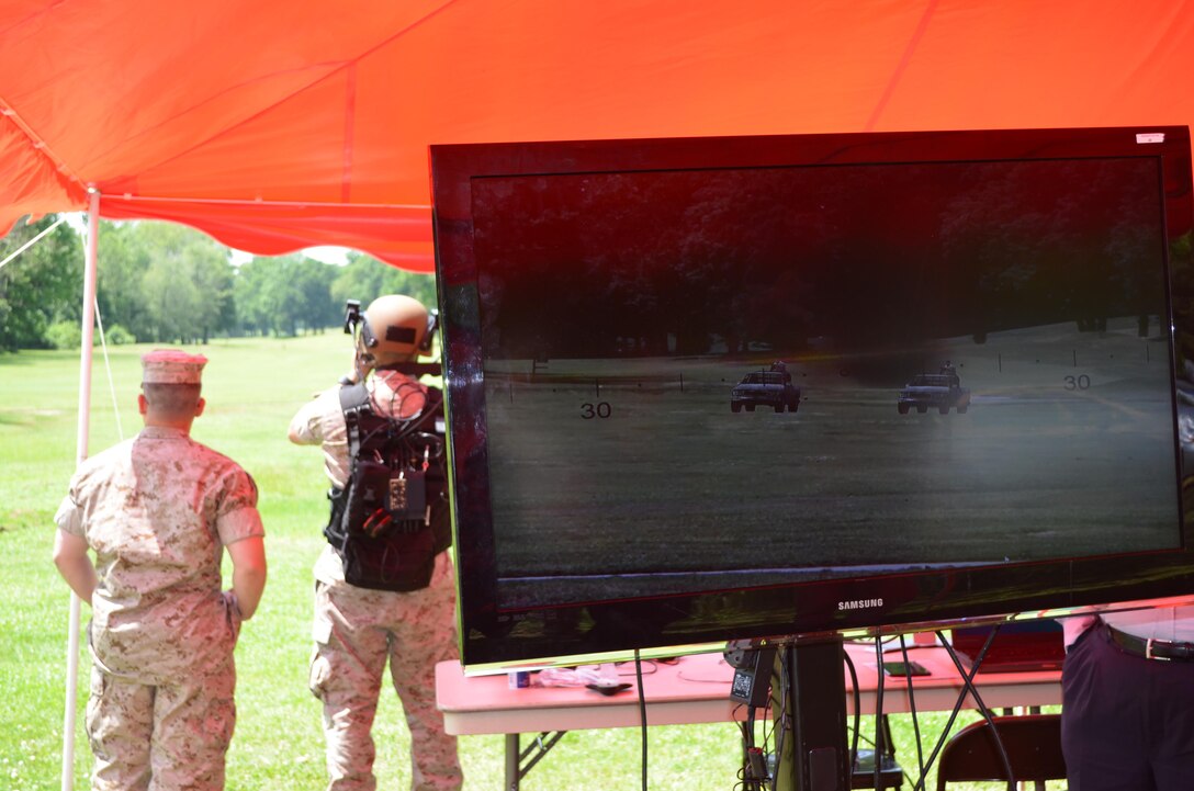 Capt. Michael Plaisier, a logistics officer at the Warfighting Lab, tests out the Augmented Immersive Team Training system on the Medal of Honor Golf Course aboard Marine Corps Base Quantico on May 20. In the display mounted to his helmet, Plaisier is viewing enemy technical vehicles moving towards him on the golf course. 