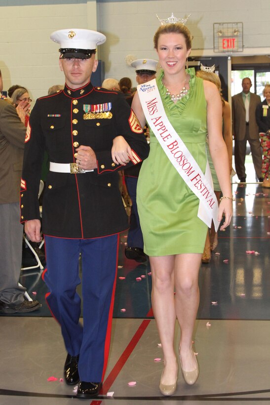 U.S. Marine Corps Staff Sgt. Norman L. Burris, left, a Roswell, New Mexico native, escorts Katie Pimblett, winner of 2015 Miss Apple Blossom Festival Pageant, May 1, 2015 during the 88th Shenandoah Apple Blossom Prayer Brunch in Winchester, Virginia. The brunch is an official event of the Apple Blossom Festival. The Marines have supported this community’s event for more than 10 years. (U.S. Marine Corps photo by Sgt. Anthony Kirby/Released)