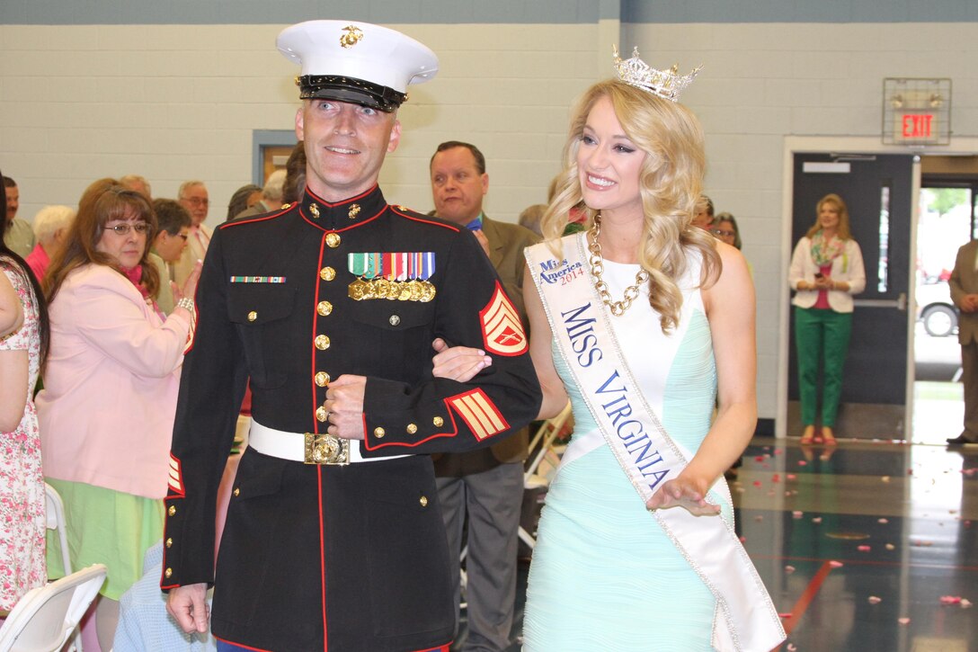 U.S. Marine Corps Staff Sgt. Daniel A. Wright, left, a native of Clear Spring, Maryland, escorts Courtney P. Garrett, 2015 Miss Virginia, May 1, 2015 during the 88th Shenandoah Apple Blossom Prayer Brunch in Winchester, Virginia. The brunch is an official event of the Apple Blossom Festival. The Marines have supported this community’s event for more than 10 years. (U.S. Marine Corps photo by Sgt. Anthony Kirby/Released)