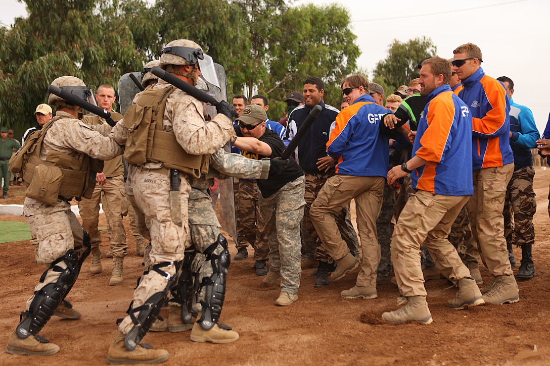 Marines with 2nd Law Enforcement Battalion demonstrate crowd control procedures against group of Moroccan, Dutch and Belgium soldiers acting as an unruly crowd May 20 in the Tifnit, Morocco, training area. Exercise African Lion 15 is an annually-scheduled, combined U.S.–Moroccan exercise designed to improve mutual understanding of each nation’s tactics, techniques and procedures while demonstrating the strong bond between the two nation’s militaries.  The one-week exercise includes various types of military training, including a command post exercise; stability operations, such as nonlethal weapons training and crisis/disaster response training.  Additionally, in February an intelligence capacity building seminar was conducted.