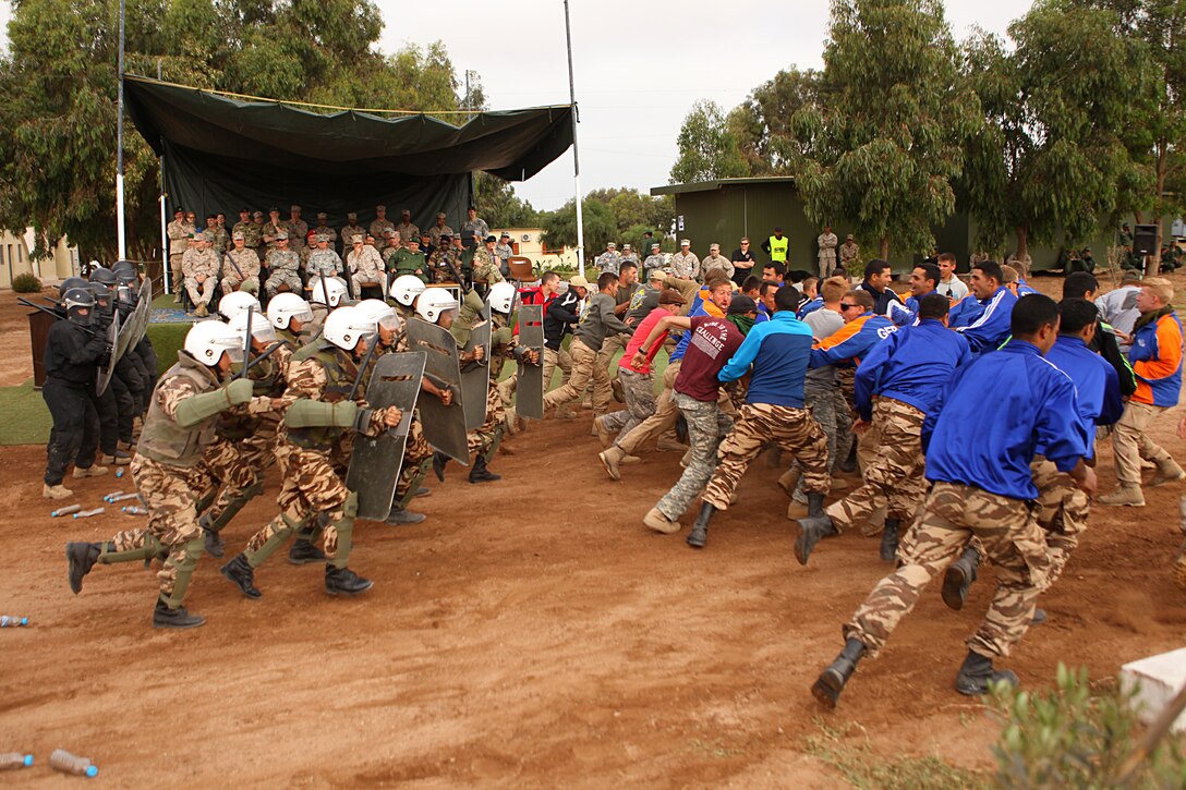 A Moroccan riot-control squad demonstrates how they disperse an unruly mob during crowd control procedures May 20 in the Tifnit, Morocco training area. Crowd control was one of several demonstrations as general officers from participating countries observed what had been accomplished during the week-long training at the camp as a part of Exercise African Lion 2015. Exercise African Lion 15 is an annually-scheduled, combined U.S.–Moroccan exercise designed to improve mutual understanding of each nation’s tactics, techniques and procedures while demonstrating the strong bond between the two nation’s militaries.  The one-week exercise includes various types of military training, including a command post exercise; stability operations, such as nonlethal weapons training and crisis/disaster response training.  Additionally, in February an intelligence capacity building seminar was conducted.