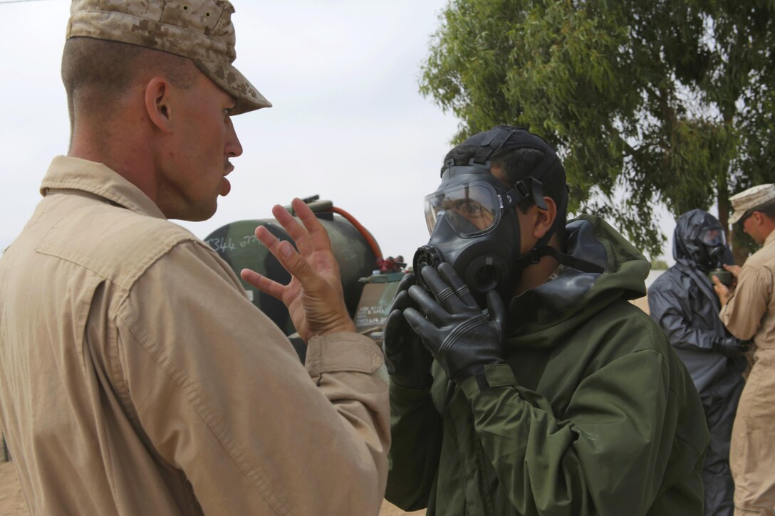A Royal Moroccan Armed Forces soldier checks his gas mask with U.S. Marine Corps Sgt. Brent Berven, Chemical, Biological Incident Response Force, before he demonstrates a decontamination procedure for the Chemical, Biological, Radiological, and Nuclear defense workshop during Exercise African Lion 15 in Tifnit, Morocco, May 16. The Royal Moroccan, U.S., U.K., Netherlands, and Belgian Armed Forces integrated while conducting peacekeeping support training to improve military capabilities and operational familiarity as one international coalition.