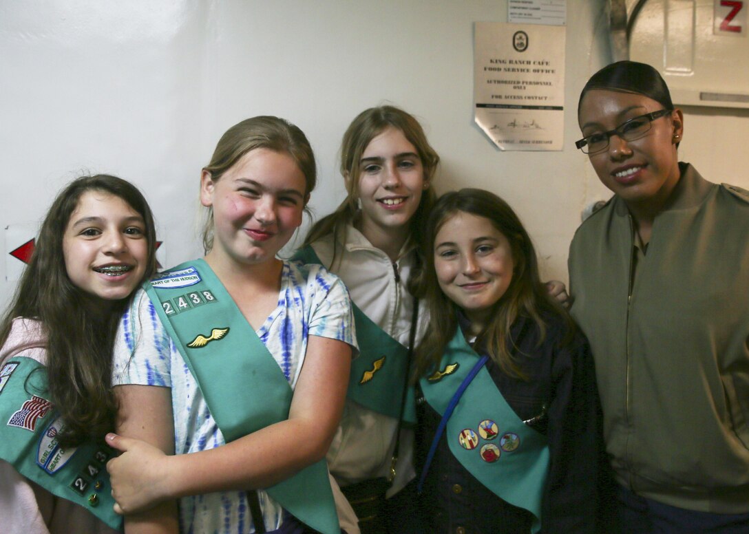 Sgt. Jerusa Argueta poses with the Heart of the Hudson Girl Scouts during their tour on USS San Antonio in New York City, May 23. The tour gave the girls opportunity for one-on-one interactions with U.S. female service members during the 2015 Fleet Week.