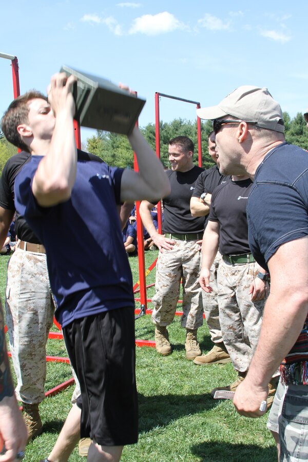 Victor Gaetan, right, encourages his son, who is in the Marine Corps Delayed Entry Program, as he performs ammunition-can lifts to win the Iron Man competition during Recruiting Station Frederick’s 2015 Annual Pool Function April 18, 2015 at Frederick Community College in Frederick, Maryland. Gaetan is a former sergeant in the U. S. Marine Corps. (U.S. Marine Corps photo by Sgt. Anthony J. Kirby/Released) 