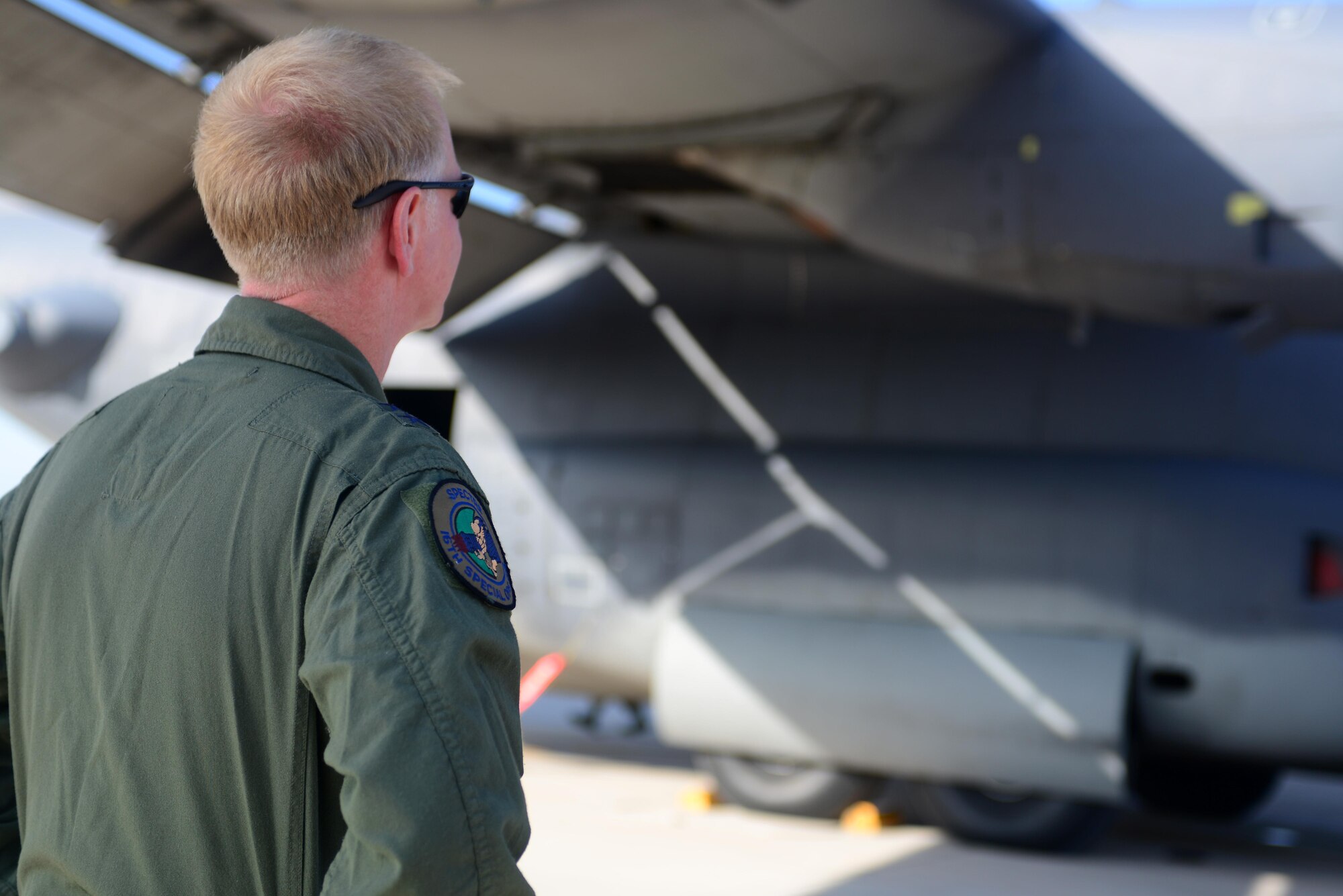U.S. Air Force Maj. Gen. Mark Hicks, Air Force Special Operations Command director of operations, watches pre-flight inspections of the AC-130H Spectre gunship, nicknamed “Excalibur”, May 27, 2015 at Cannon Air Force Base, N.M. Hicks flew the gunship to Davis-Monthan Air Force Base, Ariz., where it will be formally retired. (U.S. Air Force photo/Senior Airman Eboni Reece)