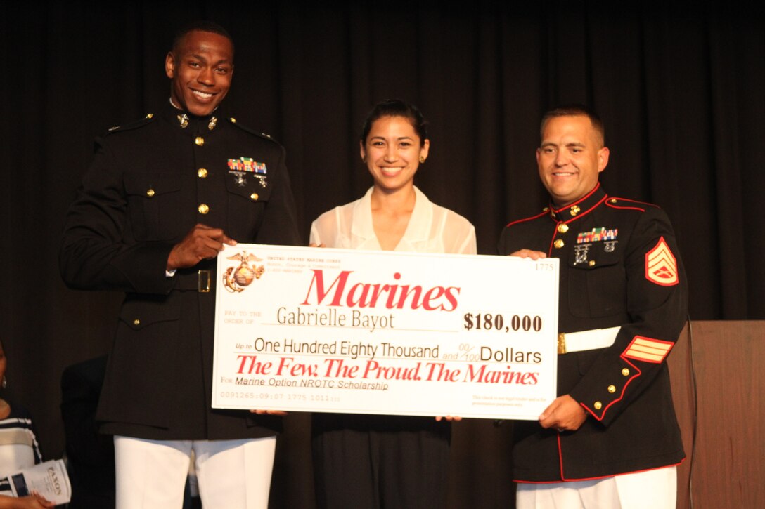 (From left to Right) Capt. Ronnie D. Jones, Gabrielle Bayot and Staff Sgt. Shawn M. Faglier pose for a photo after awarding a Naval Reserve Officer Training Corps check at Paxon School for Advanced Studies, Jacksonville, Fla., May 26, 2015. Bayot was selected to receive $180,000 scholarship among 45 applicants from Recruiting Station Jacksonville, Fla.
