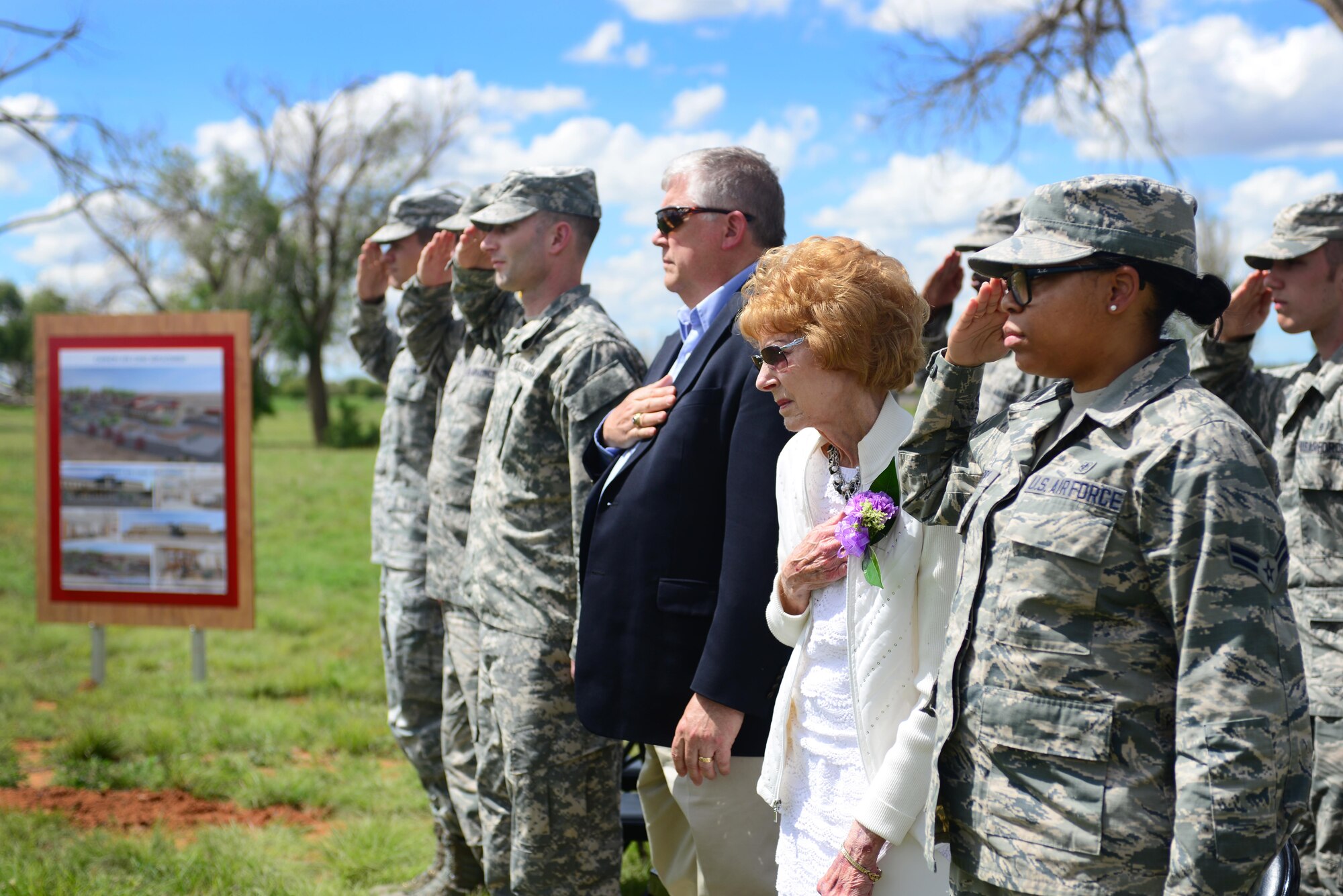 Participants show their respects to the flag during the presentation of colors at the medical clinic groundbreaking ceremony, May 26, 2015 at Cannon Air Force Base, N.M. The new Cannon medical clinic is striving for Leadership in Energy and Environmental Design Silver Certification, and construction is scheduled to be completed in 2018. (U.S. Air Force photo/ Senior Airman Eboni Reece)