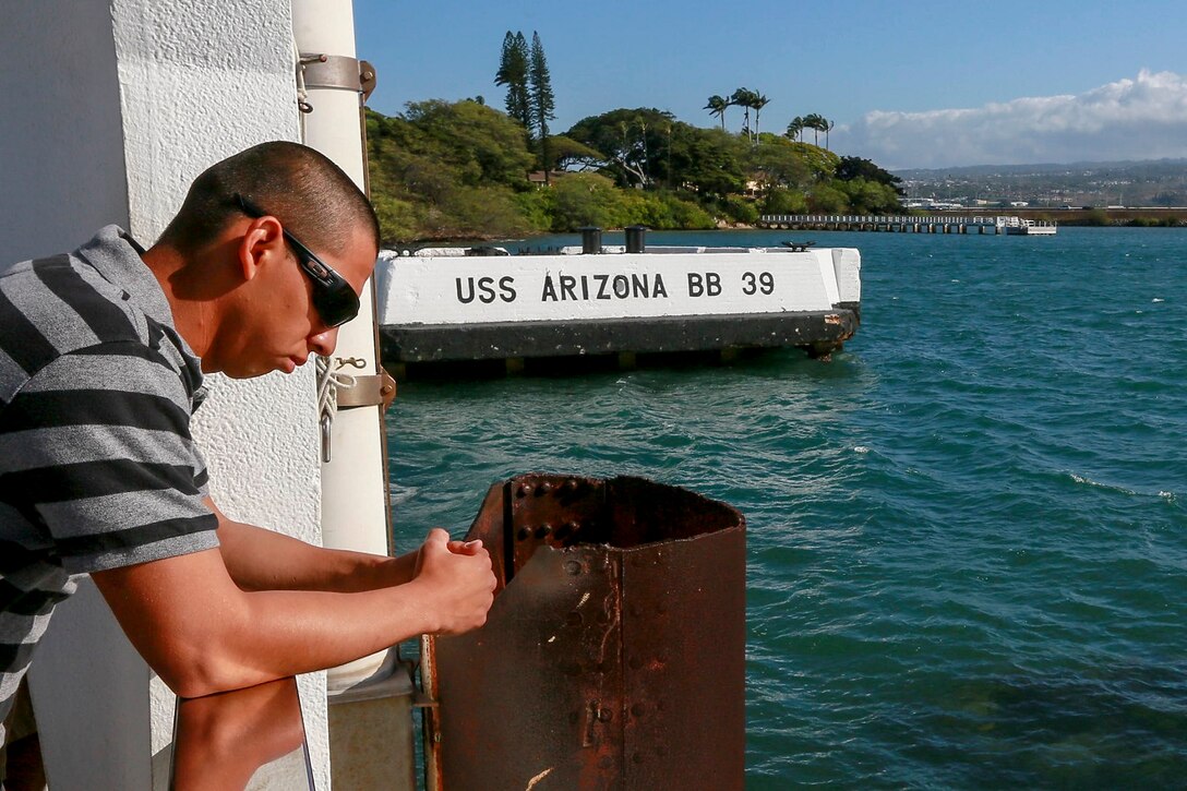 A U.S. Marine with India Company, Battalion Landing Team 3rd Battalion, 1st Marine Regiment, 15th Marine Expeditionary Unit, honors fallen veterans at the USS Arizona Memorial at Pearl Harbor in Honolulu, Hawaii, May 19, 2015. The Marines of BLT 3/1 took a moment to remember their predecessors in honor of Memorial Day. (U.S. Marine Corps photo by Sgt. Jamean Berry/Released)