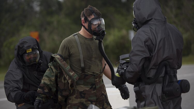 An explosive ordnance disposal technician undergoes the decontamination process after leak, seal, package and decontamination training April 21 at the gas chamber on Camp Hansen, Okinawa. The EOD technicians and Chemical, biological radiological, nuclear defense specialists used protective equipment to perform general decontamination of the affected area and prepare the leaking ordnance for safe containment and transport before completing the decontamination process. 