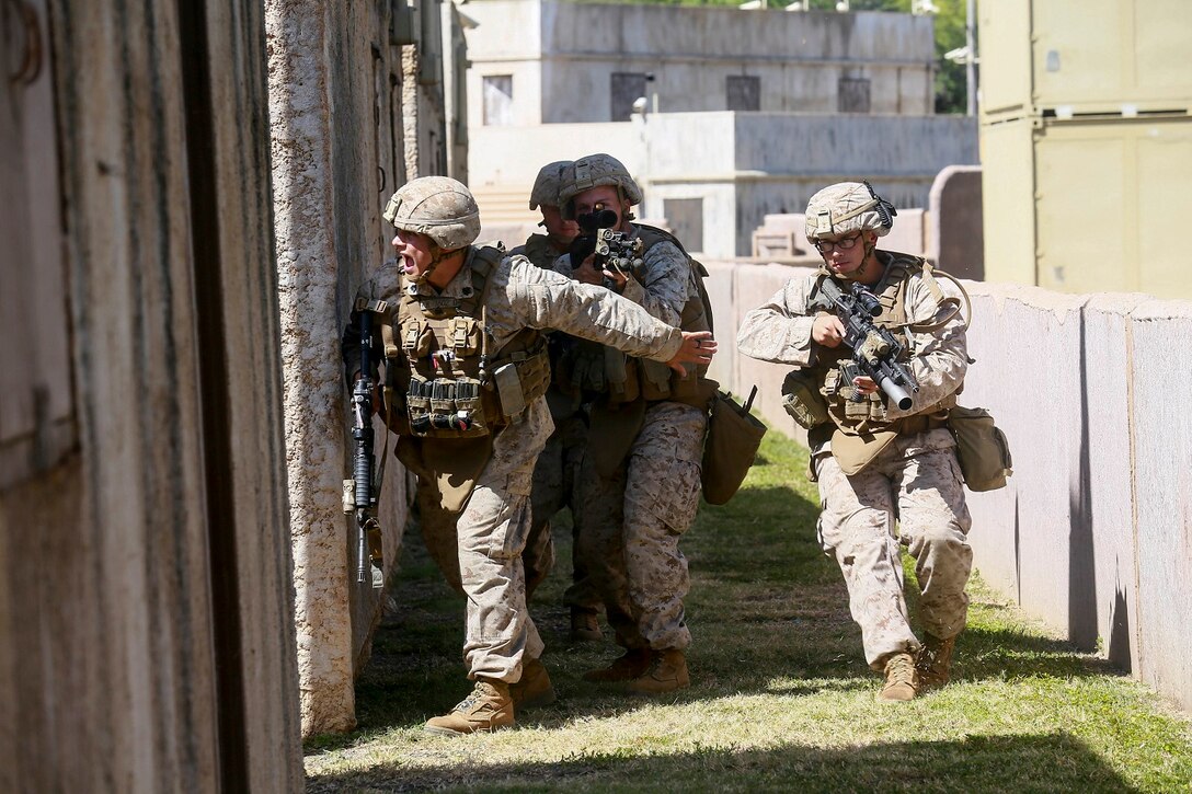 U.S. Marines with India Company, Battalion Landing Team 3rd Battalion, 1st Marine Regiment, 15th Marine Expeditionary Unit, clear an alley aboard Bellows Air Force Station, Hawaii, May 15, 2015. The Marines of BLT 3/1 used Hawaii’s unique environment and training areas to prepare for possible scenarios in their upcoming deployment. (U.S. Marine Corps photo by Sgt. Jamean Berry/Released)