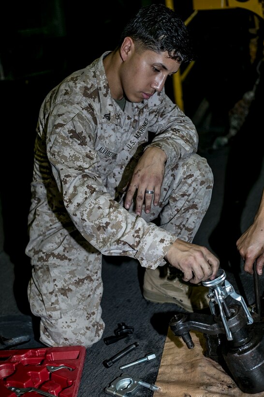 U.S. Marine Cpl. Irving Alvarez conducts routine maintenance on a Humvee aboard the USS Essex (LHD 2) at sea in the Pacific Ocean, May 24, 2015. Alvarez is a general mechanic with Battalion Landing Team 3rd Battalion, 1st Marine Regiment, 15th Marine Expeditionary Unit. Ensuring all equipment is in good condition is essential to the MEU’s combat readiness. (U.S. Marine Corps photo by Cpl. Anna Albrecht/Released)