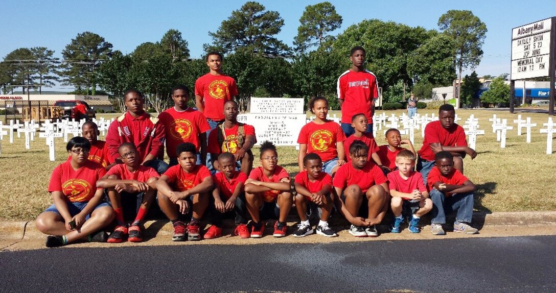 The Young Marines of Albany, Georgia, assemble in front of the Albany Mall with Master Sgt. Nathaniel Lowman, May 23.  The Young Marines helped to place flags and crosses in memory of the nation’s fallen service members.