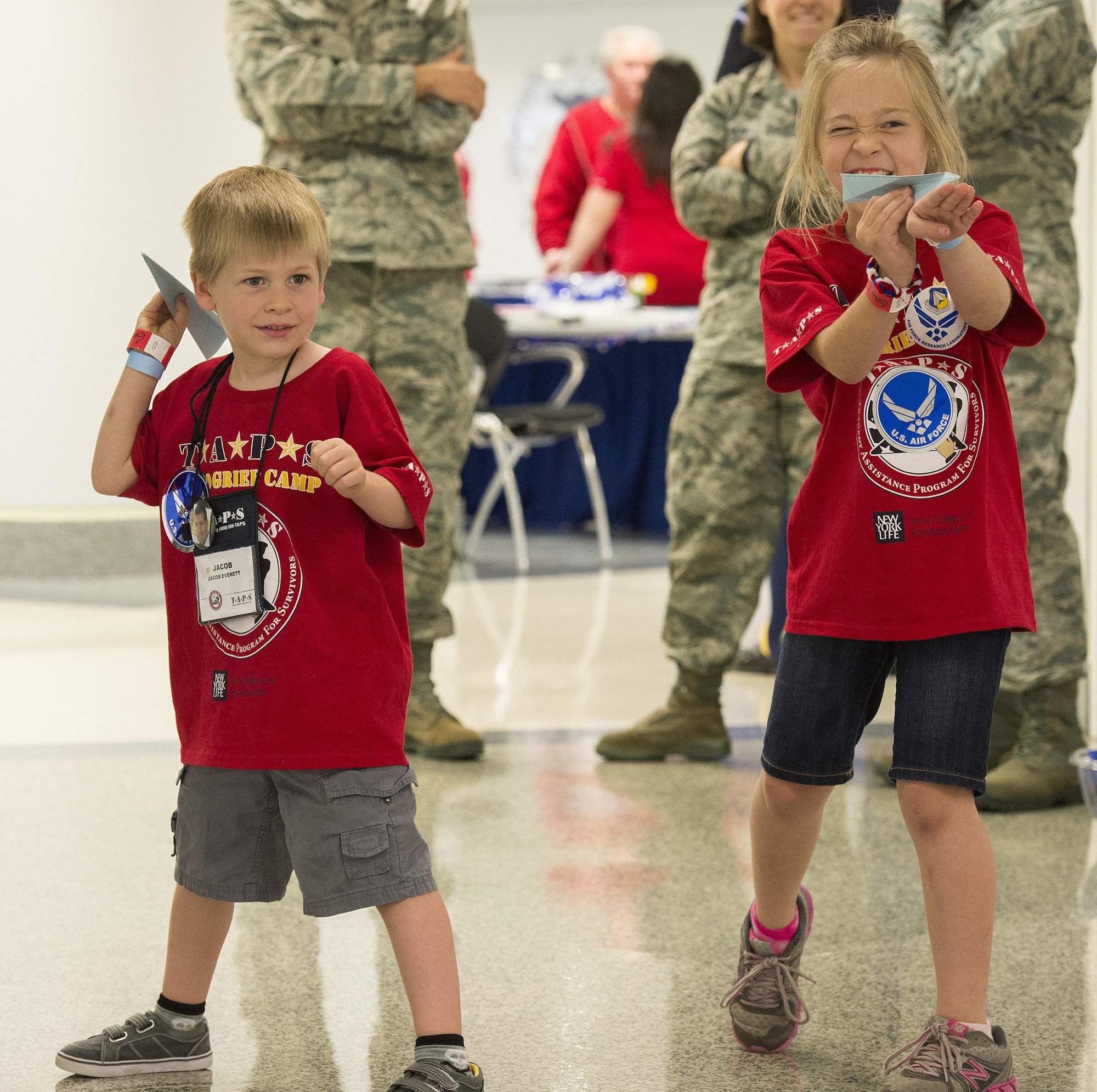 Youths make and fly paper airplanes during a 21st Annual Tragedy Assistance Program for Survivors (TAPS) Military Survivor Seminar and Good Grief Camp for Young Survivors event at the Pentagon in Washington, D.C., May 22, 2015.  The TAPS Good Grief Camp for children and teens provides a safe and supportive atmosphere for kids to learn coping skills, establish and identify support systems, and create awareness that they are not alone in their grief. (U.S. Air Force photo/Jim Varhegyi)