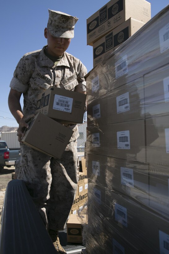 Pvt. David Jaramillo, student, Marine Corps Communication-Electronics School, loads boxes of coffee onto a truck during the Chaplain’s coffee giveaway at the Distribution Management Office, May 19, 2015. Holy Joe’s Café donated approximately 750 thousand cups of coffee to the units of the Combat Center. (Official Marine Corps photo by Lance Cpl. Thomas Mudd/Released)