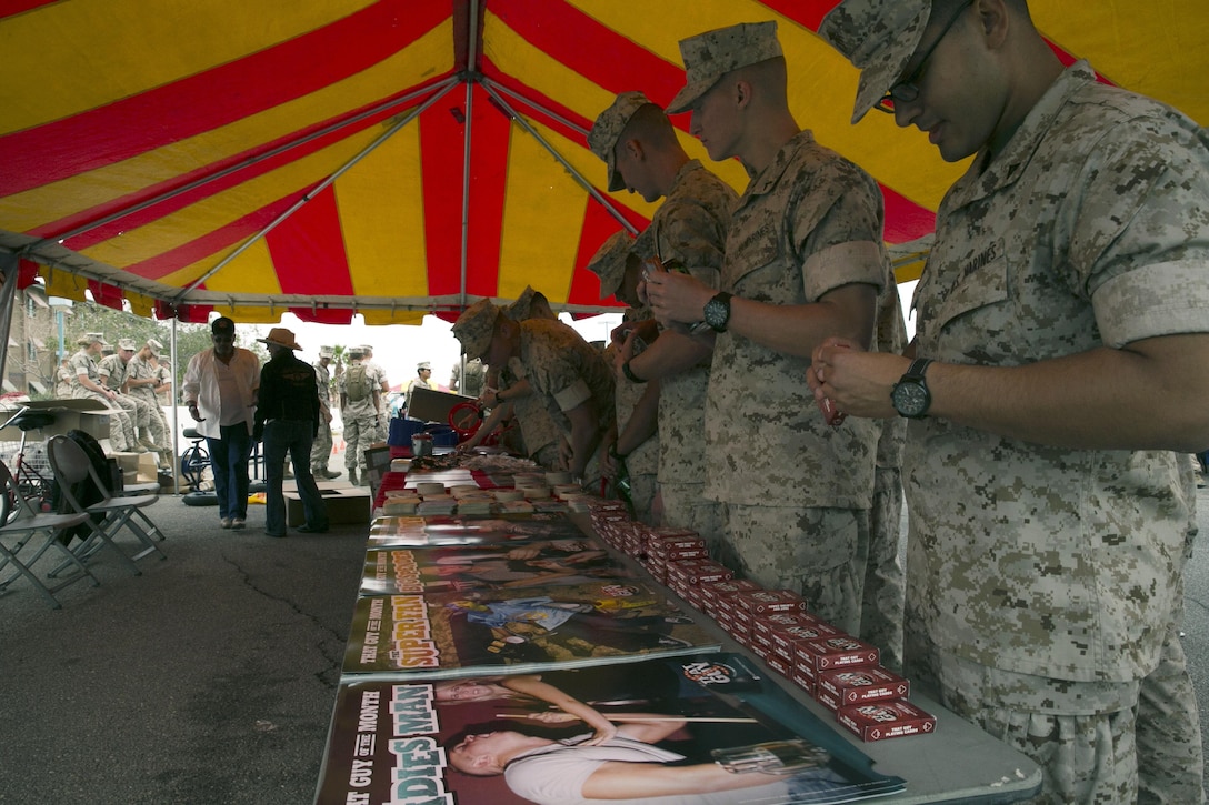 Marines visit the Substance Abuse Control Office booth during the Marine Corps Communication-Electronics School Safety Fair at the MCCES barracks parking lot, May 15, 2015. Approximately 3,000 Marines attended  the fair. (Official Marine Corps photo by Lance Cpl. Thomas Mudd/ Released)