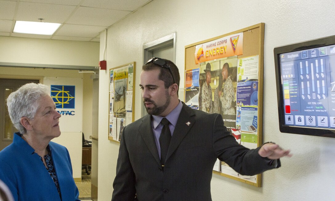 Mick Wasco, the Marine Corps Air Station Miramar Energy Program Manager, talks to Gina McCarthy, the U.S. Environmental Protection Agency Administrator, about energy conservation efforts at the public works building aboard MCAS Miramar, California, May 20. The station reduced its total fuel oil consumption by 98% by building a new aircraft hangar, which brought a natural gas system to the installation and eliminated the old diesel fuel system in 2014.