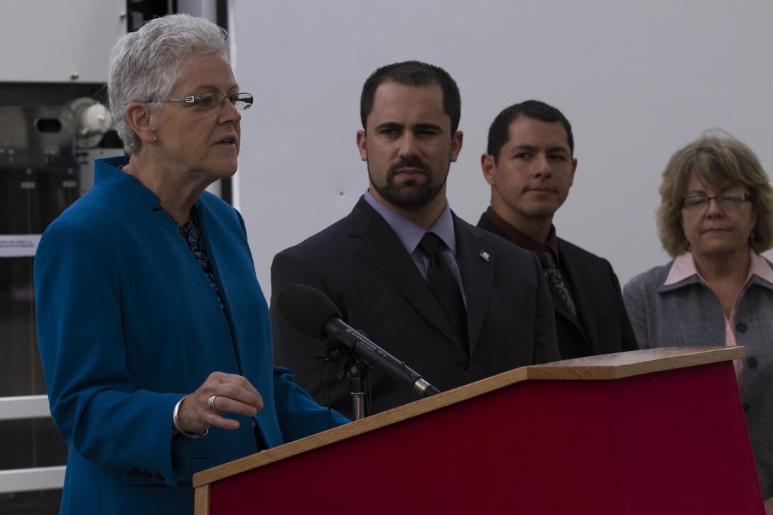 Gina McCarthy, the U.S. Environmental Protection Agency Administrator, congratulates Marine Corps Air Station Miramar, California on receiving the 2015 EPA Federal Green Challenge Award for Energy at the public works building on Marine Corps Air Station Miramar, California, May 20. The station received the award because it had the greatest percentage reduction in energy use nationwide in 2014.