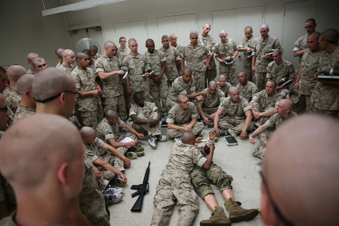 Recruits of India Company, 3rd Recruit Training Battalion, take turns assessing and treating combat injuries on a training dummy at Marine Corps Recruit Depot San Diego, May 19. The group setting allowed recruits to help one another when a recruit had trouble treating a simulated injury. Today, all males recruited from west of the Mississippi are trained at MCRD San Diego. The depot is responsible for training more than 16,000 recruits annually. Company I is scheduled to graduate from recruit training on July 21.