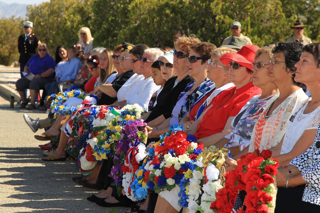 Various representatives from the Twentynine Palms community serve as wreath bearers during the Memorial Day Remembrance Ceremony held at Twentynine Palms Memorial Cemetery May 25, 2015. Maj. Gen. Lewis Craparotta, Combat Center Commanding General, served as the guest speaker and the Combat Center Color Guard and a rifle detail from Headquarters Battalion volunteered their services during the ceremony. (Official USMC photo by Lauren Kurkimilis/Released)