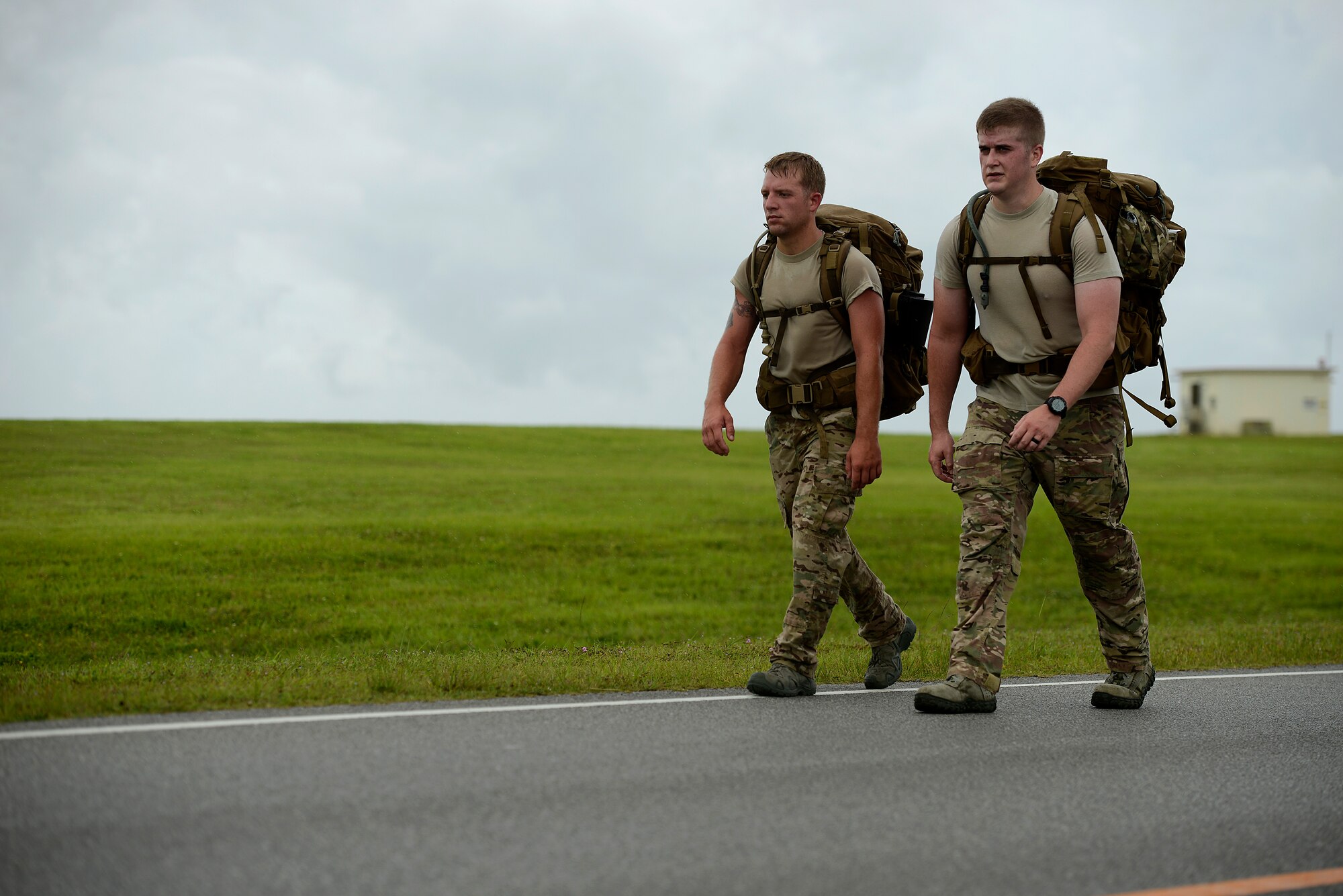 U.S. Air Force Staff Sgts. Adam Worcester and Sean Boes, both from the 353rd Special Operations Group, participate in an 8.5-mile march around the Kadena Air Base, Japan, flightline May 23, 2015. Military members from all branches of service on Okinawa, civilian government employees and their families participated in an 8.5-mile march to commemorate the prisoners of war who were a part of the Battle of Bataan in the Philippines during World War II. (U.S. Air Force photo by Staff Sgt. Maeson L. Elleman)