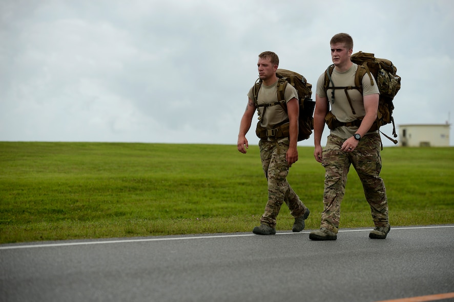 U.S. Air Force Staff Sgts. Adam Worcester and Sean Boes, both from the 353rd Special Operations Group, participate in an 8.5-mile march around the Kadena Air Base, Japan, flightline May 23, 2015. Military members from all branches of service on Okinawa, civilian government employees and their families participated in an 8.5-mile march to commemorate the prisoners of war who were a part of the Battle of Bataan in the Philippines during World War II. (U.S. Air Force photo by Staff Sgt. Maeson L. Elleman)