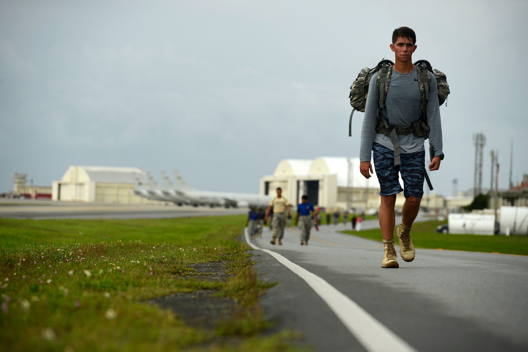 Joint military forces, government civilian employees and their families participate in an 8.5-mile march around the Kadena Air Base, Japan, flightline May 23, 2015. The Bataan Memorial Death March memorial ruck was held to honor the American and Filipino servicemen who defended the island of Luzon in the Philippines in 1942 and had to march more than 60 miles. Participants endured the march with weighted packs as a tribute to those who were forced through the unforgiving event during World War II. (U.S. Air Force photo by Staff Sgt. Maeson L. Elleman)