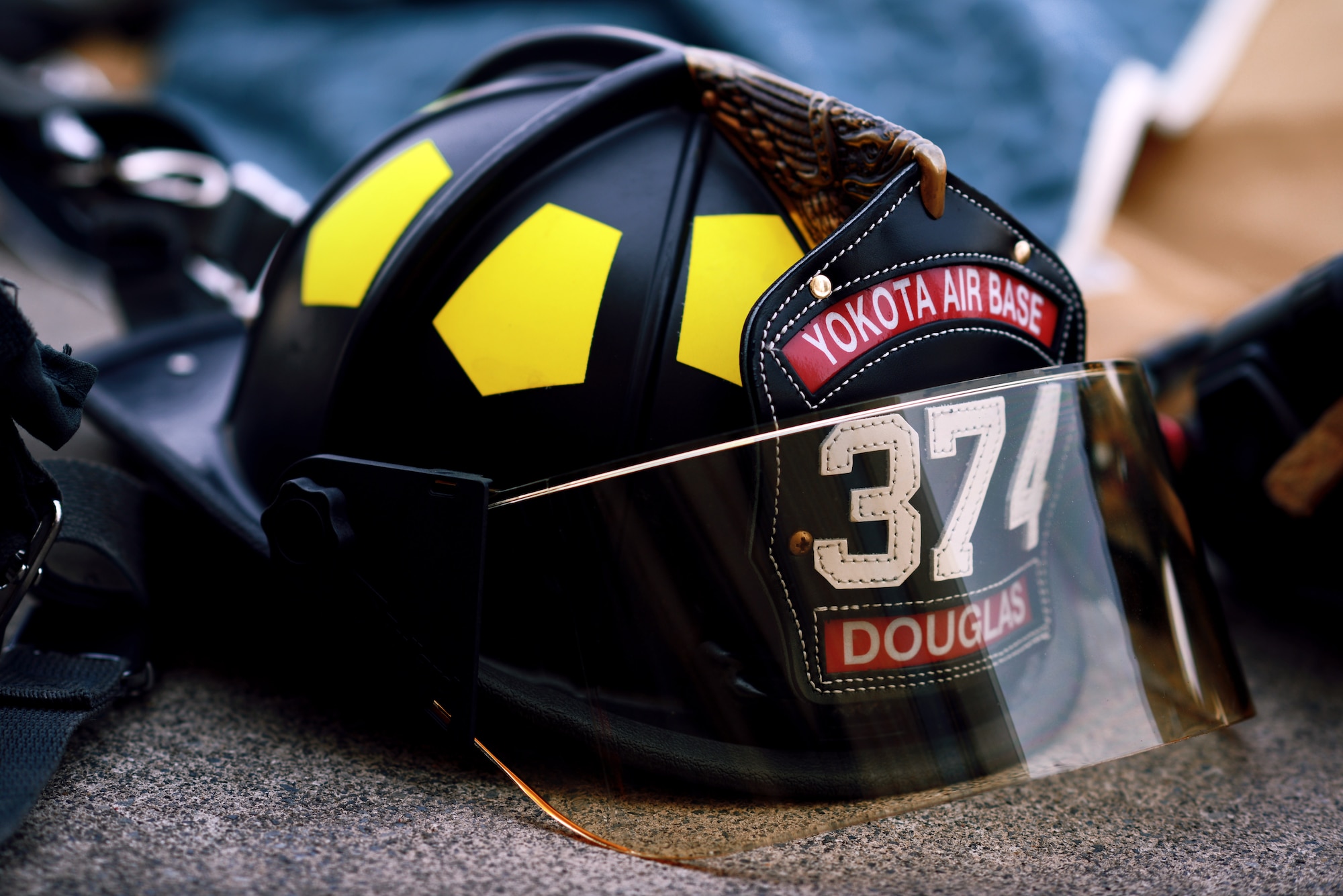 A 374th Civil Engineer Squadron firefighter helmet lays amongst equipment during a joint fire training exercise May 26, 2015, at Yokota Air Base, Japan. This opportunity allowed for the 374 CES and Japan Air Self-Defense Force firefighters to exchange information and learn how one another perform fire protection duties. (U.S. Air Force photo by Airman 1st Class Delano Scott/Released)