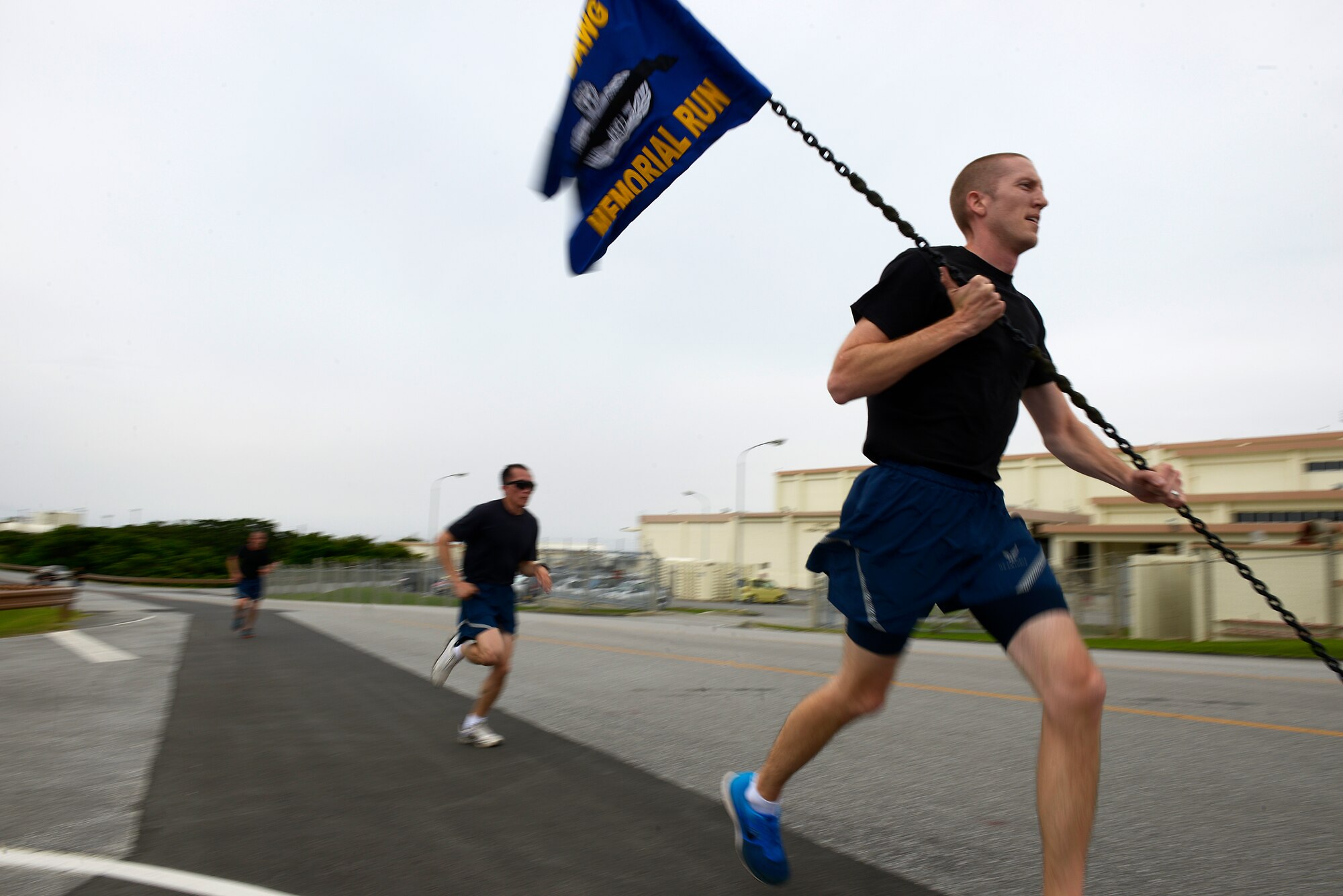 A U.S. Air Force Airman carries the “Port Dawg Memorial Run” guidon as he participates in the second annual event on Kadena Air Base, Japan, May 21, 2015. The run, which is held on several bases around the world each year, was enacted to honor those from the career field who have fallen since the last time the event was held. (U.S. Air Force photo by Staff Sgt. Maeson L. Elleman)