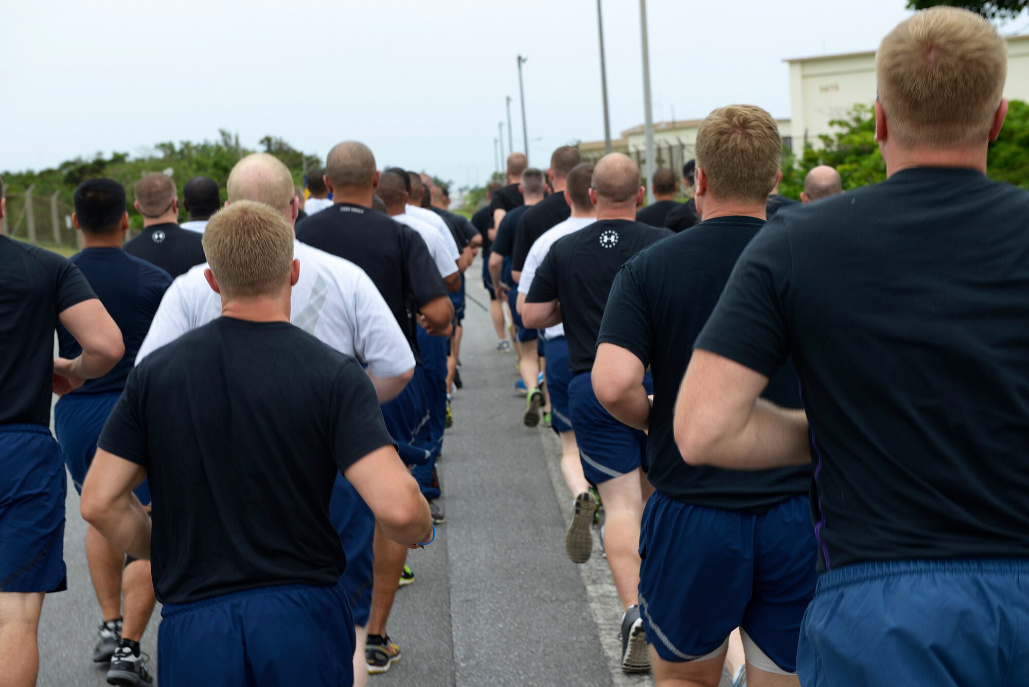 U.S. Air Force members of the 733rd Air Mobility Squadron run in formation during the second annual “Port Dawg” memorial run on Kadena Air Base, Japan, May 21, 2015. The run, which is held on several bases around the world each year, was enacted to honor those from the career field who have fallen since the last time the event was held. (U.S. Air Force photo by Staff Sgt. Maeson L. Elleman)