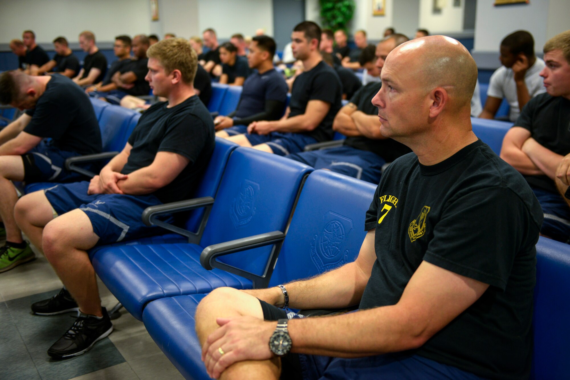 U.S. Air Force members of the 733rd Air Mobility Squadron listen to a reading of the names of all aerial porters who have passed away since last year before embarking on the second annual “Port Dawg” memorial run on Kadena Air Base, Japan, May 21, 2015. The run, which is held on several bases around the world each year, was enacted to honor those from the career field who have fallen since the last run. (U.S. Air Force photo by Staff Sgt. Maeson L. Elleman)