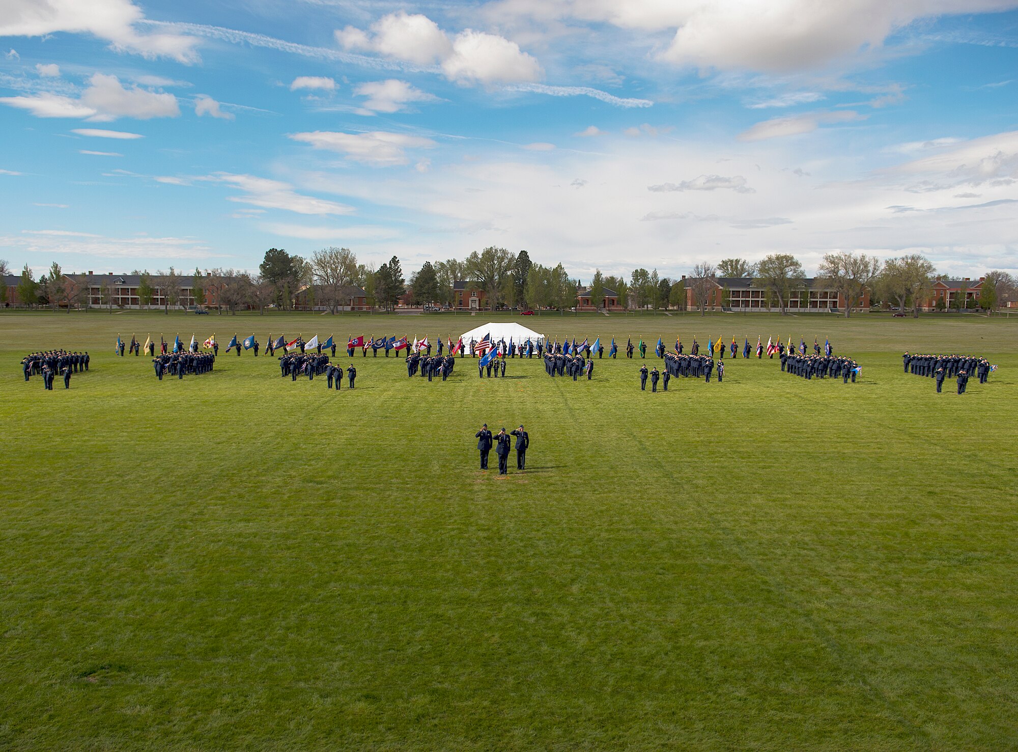 Airmen of the 90th  Missile Wing Stand in formation on Argonne Parade Field, F.E. Warren Air Force Base, Wyo., May 27, 2015, prior to a change of command ceremony. Col. Stephen M. Kravitsky assumed command of the wing during the ceremony. (U.S. Air Force photo by R.J. Oriez)
