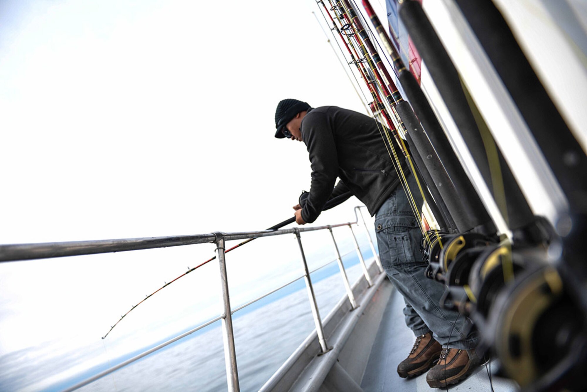 Jason Dictian, a bioenvironmental technician with the 673d Aerospace Medicine Squadron, and native of Chicago, IL fishes out of the water outside Seward, Alaska May 20 as part of the 2015 Annual Armed Services Combat Fishing Tournament. Military service members competed for a plethora of awards, including a $2,000 randomly selected fish weight. (U.S. Air Force photo/Airman 1st Class Kyle Johnson)



