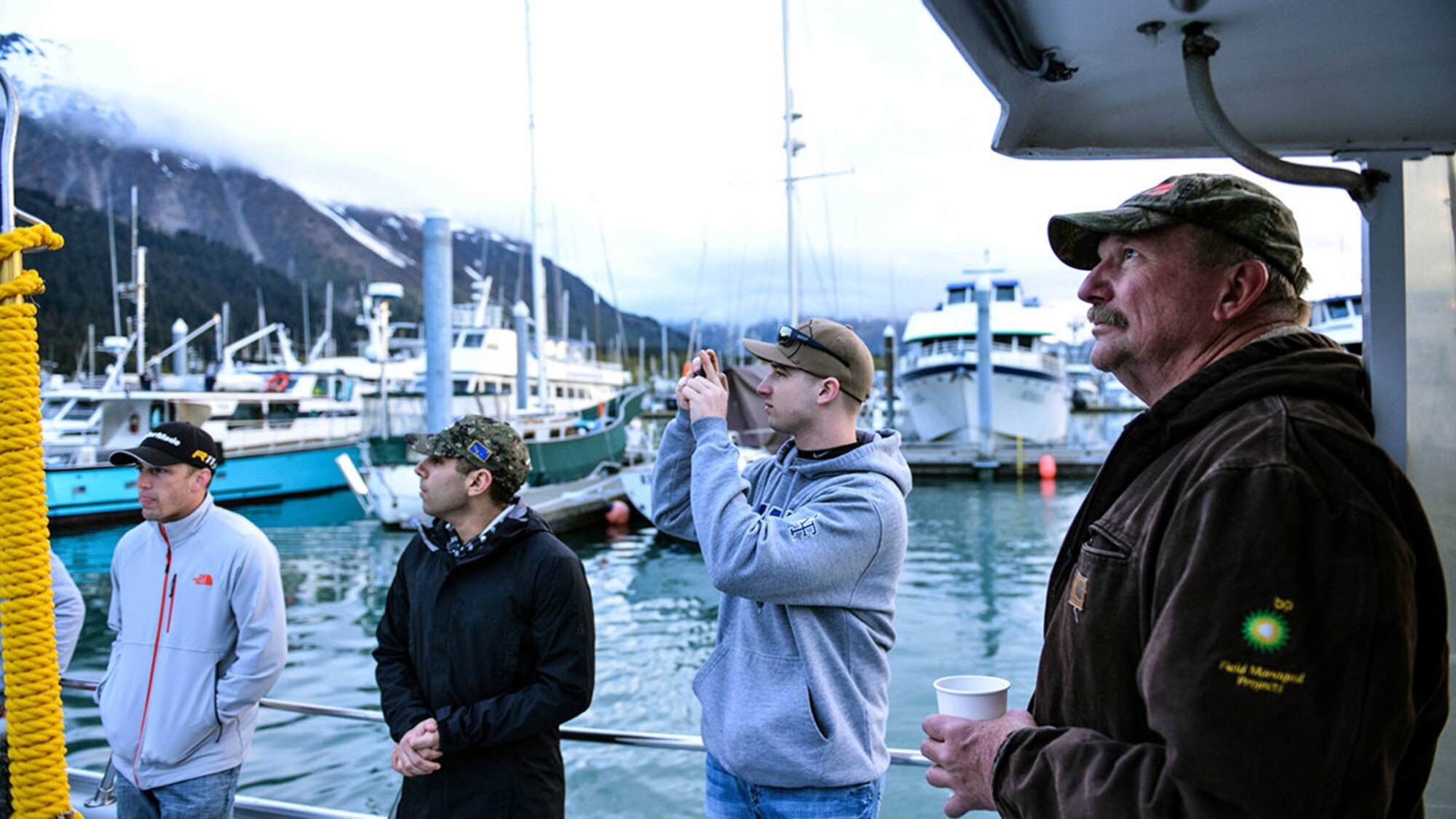 Army veteran Rich Davis relaxes with a cup of coffee as he waits for boats to depart harbor in Seward, Alaska May 20, 2015. His vessel, and dozens others carried more than 200 participants into 200-to-300-foot Alaskan waters to ply their luck for halibut and rock fish. (U.S. Air Force photo/Airman 1st Class Kyle Johnson)