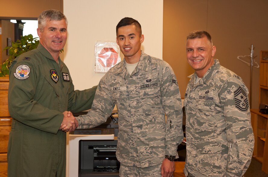 Airman 1st Class James Atwell, a 71st Force Support Squadron force management journeyman, receives a 71st Flying Training Wing commander’s coin from Col. John Menozzi, the 71st FTW vice commander, May 11 at Vance Air Force Base, Oklahoma and Chief Master Sgt. Peter Speen, the 71st FTW command chief. Menozzi and Col. Christopher Daniels, the 71st Mission Support Group commander, recognized Atwell as the 71st FTW Airman of the Month for May. (U.S. Air Force photo / Tech. Sgt. James Bolinger)
