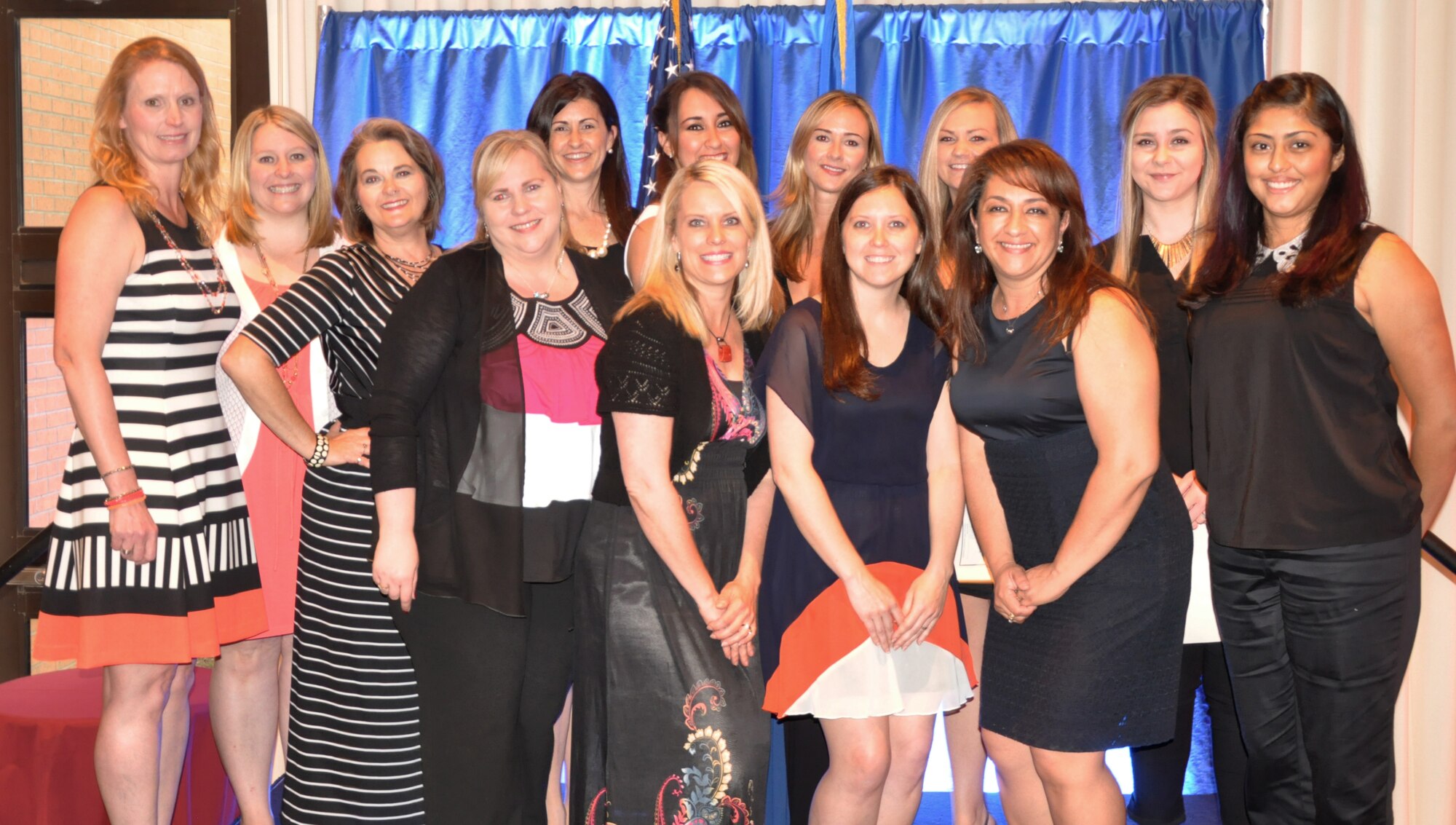 Members of the Officers’ Spouses’ Club at Vance and the 2015 OSC scholarship recipients stand on stage at the Vance Collocated Club at Vance Air Force Base, Oklahoma, May 12. The OSC presented 15 scholarships, totaling $16,000 to Vance spouses and high school seniors during a formal dinner. (U.S. Air Force photo / 2nd Lt. Isabel Crump)