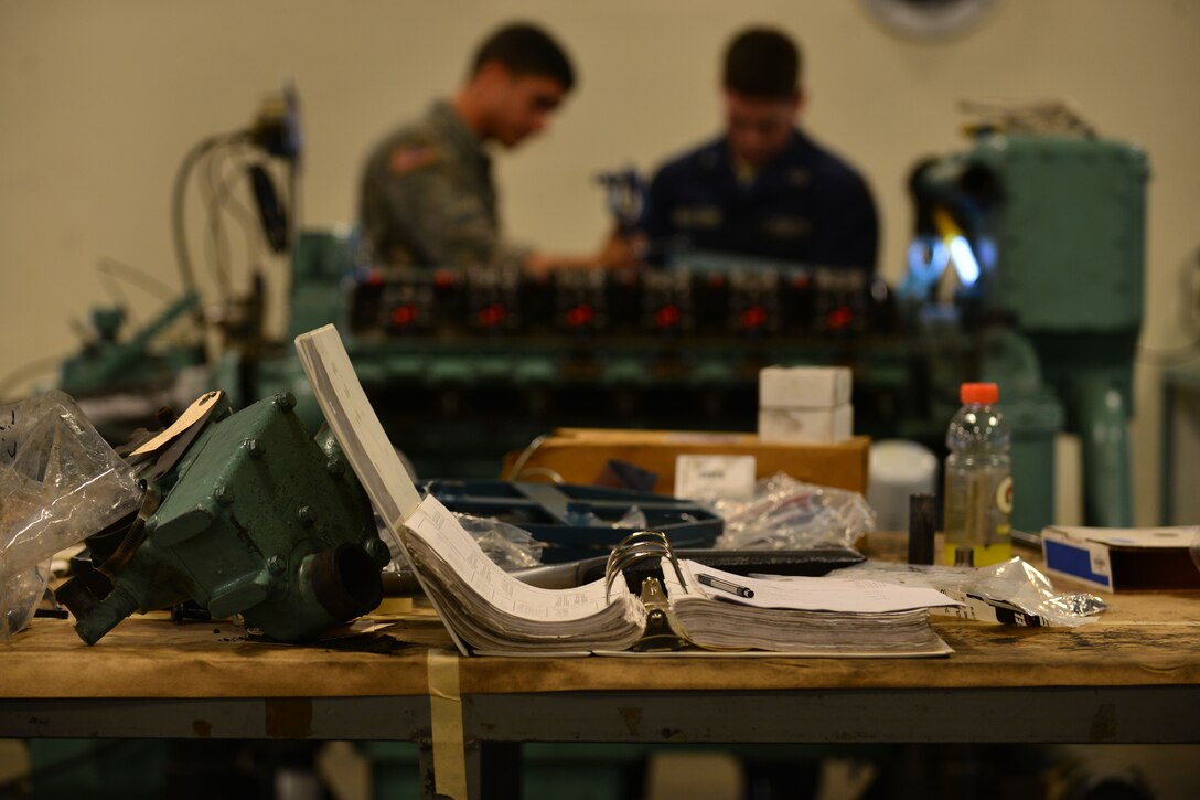 U.S. Army 2nd Staff and Faculty Watercraft Engineer Certification Course students rebuild Detroit diesel 12-V-71 series main propulsion engines according to technical manuals at Fort Eustis, Va., May 21, 2015. The engines are rebuilt according to the engine’s technical manual and safety notes to ensure no mechanical or safety mishaps occur. (U.S. Air Force photo by Staff Sgt. Natasha Stannard/Released)
