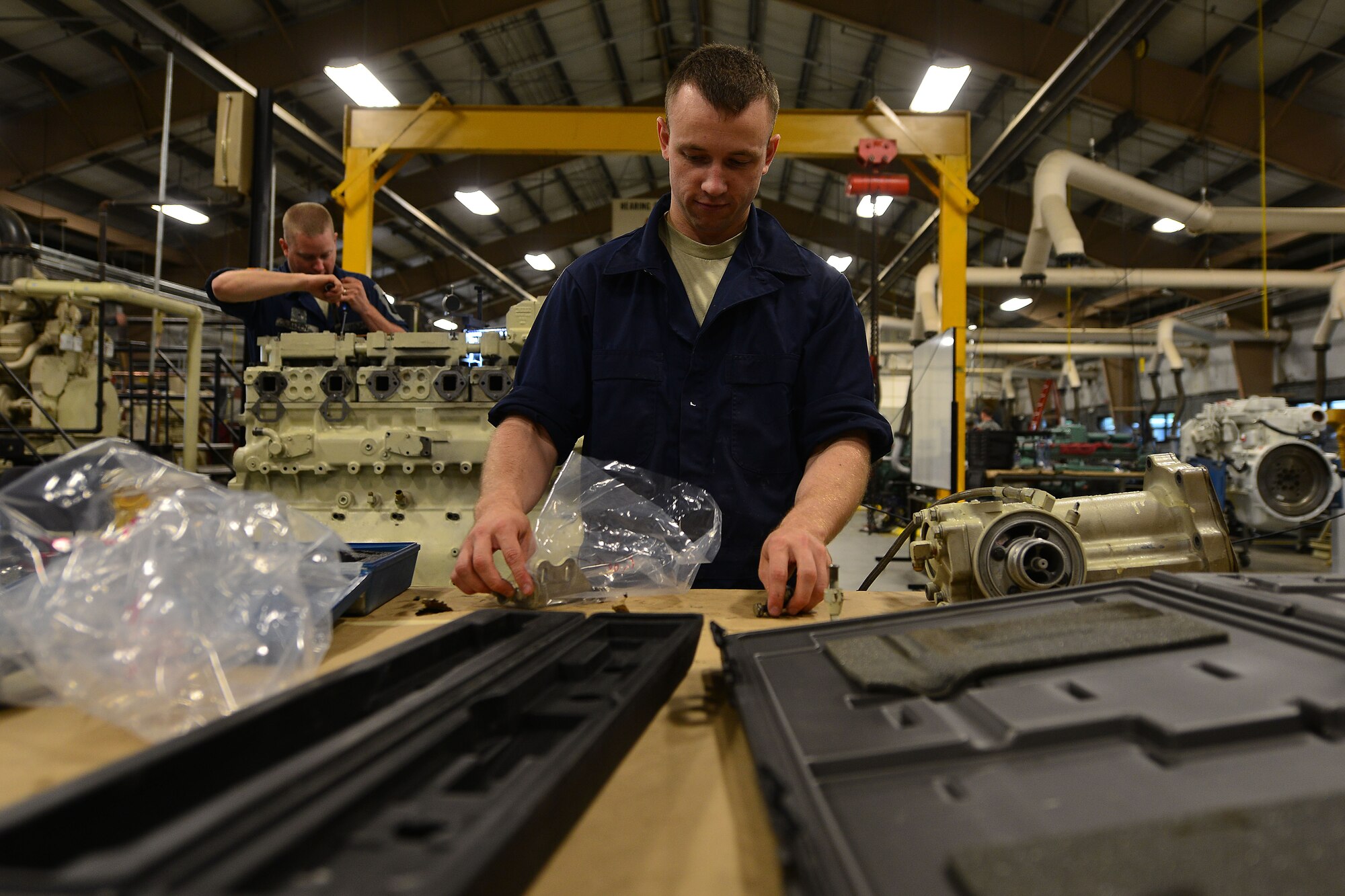 U.S. Army Warrant Officer Lewis Bryce, 2nd Staff and Faculty Company Marine Engineering Officer Basic Course student, gathers tools to perform a tune-up on a diesel Landing Craft Utility-2000 generator at Fort Eustis, Va., May 21, 2015. Tune-ups are annual services performed on generators as well as for most other Army vessels and boat generators. (U.S. Air Force photo by Staff Sgt. Natasha Stannard/Released)
